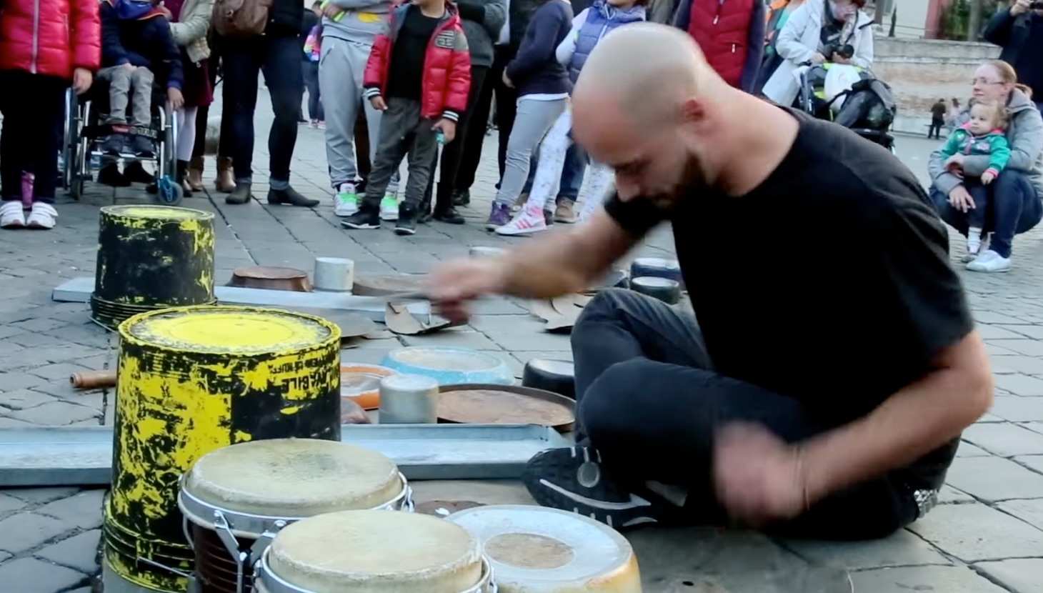 Street Performer “Drums Out” Techno Music Using Drum Sticks, Woks and