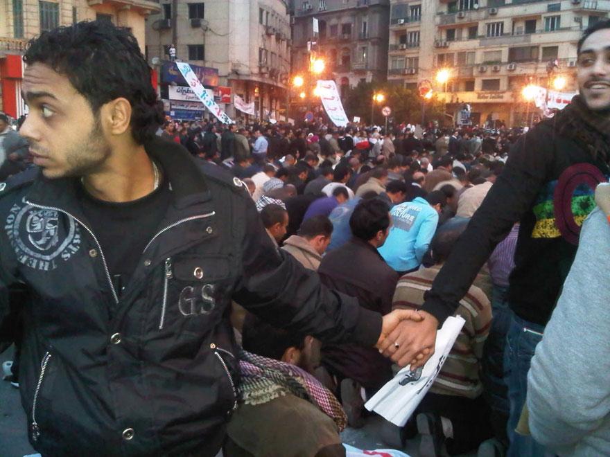 15. Christians protect muslims during a prayer in Cairo, Egypt