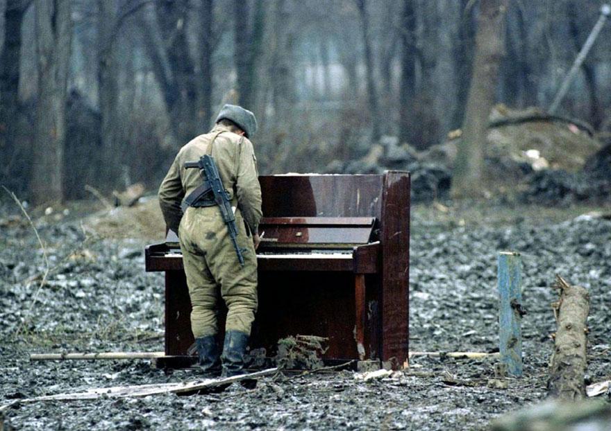 17. A Russian soldier playing abandoned piano