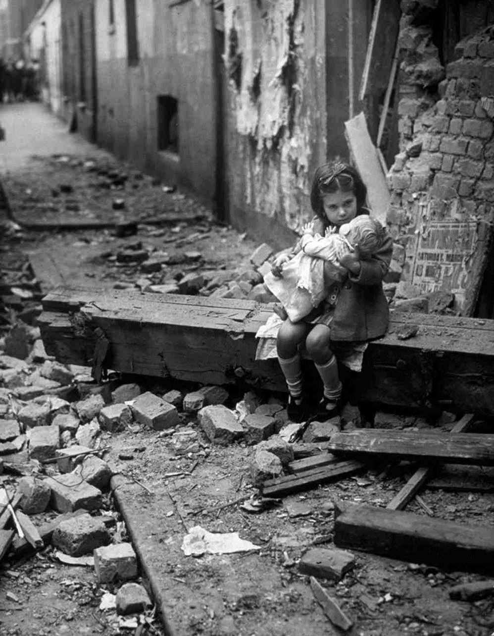 21. An English Girl near her bomb-damaged home 1940